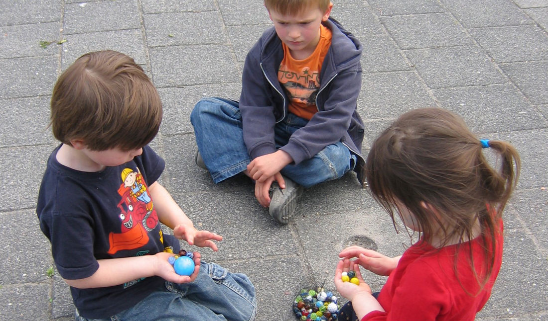Children negotiating marbles